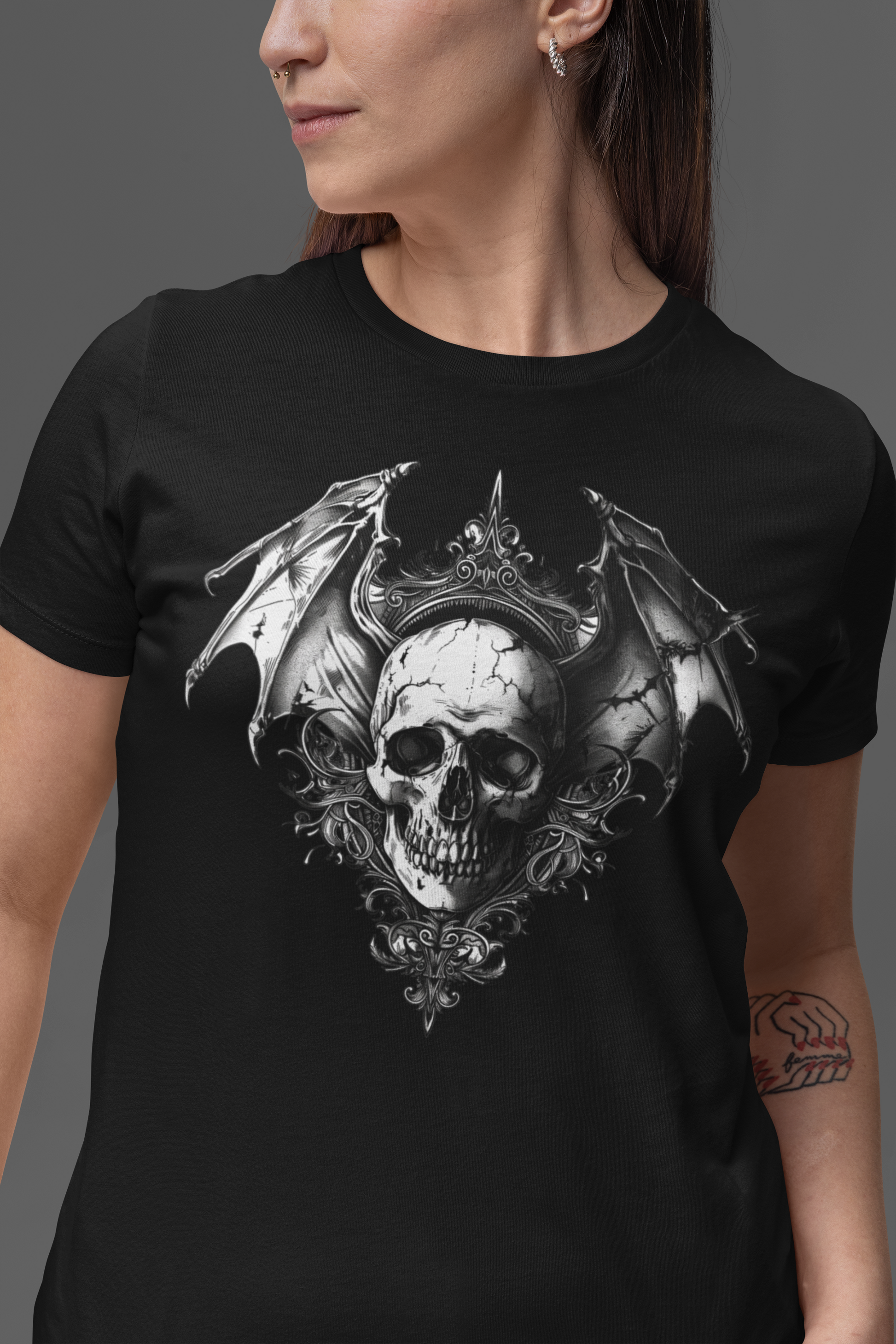 Gothic bat-winged skull with intricate dark ornaments, perfect for gothic fashion, occult aesthetics, and alternative streetwear. Gothic Bat Winged Skull Short-Sleeve Unisex T-Shirt - DarkSongWear