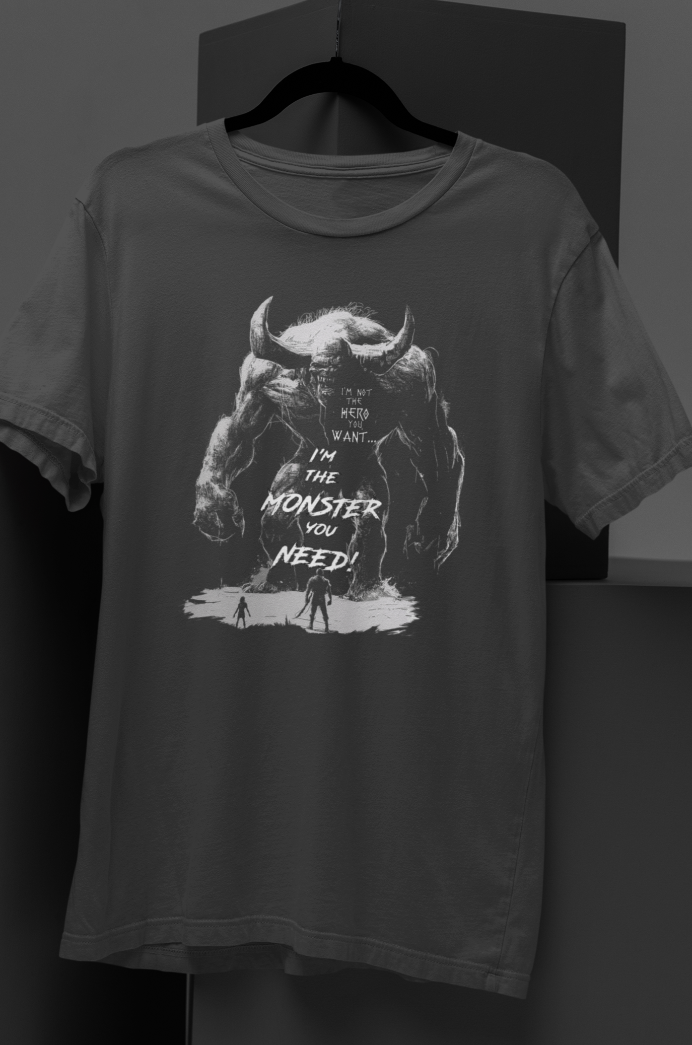 A white-on-black illustration of a gigantic horned demon wielding a club, facing a tiny human figure. Symbolizing the inner monster that must be unleashed at times. Perfect for dark gothic art, occult aesthetics, and alternative fashion.II'm Not The Hero You Want - DarkSongWear